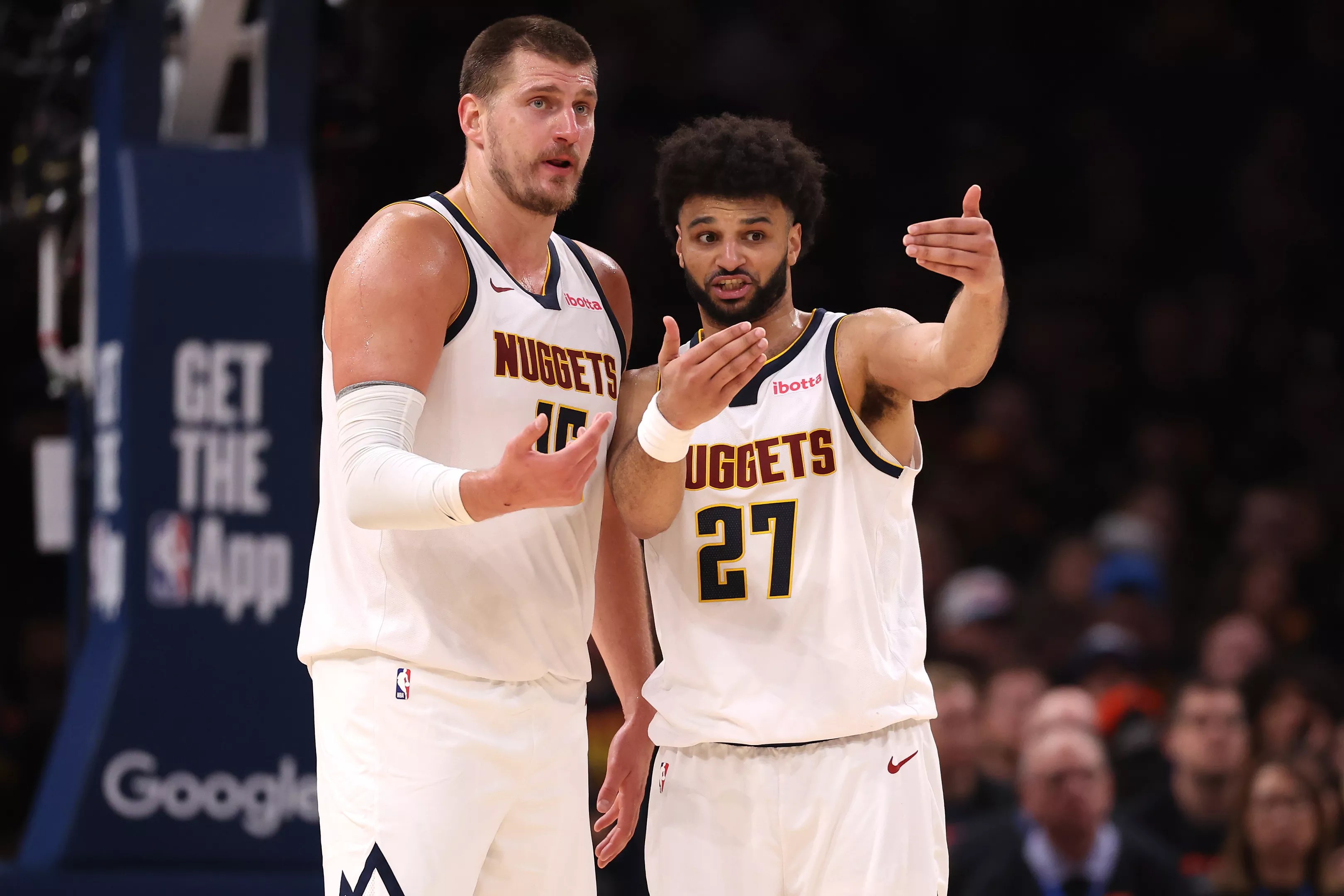 Nikola Jokic and Jamal Murray talk during game
