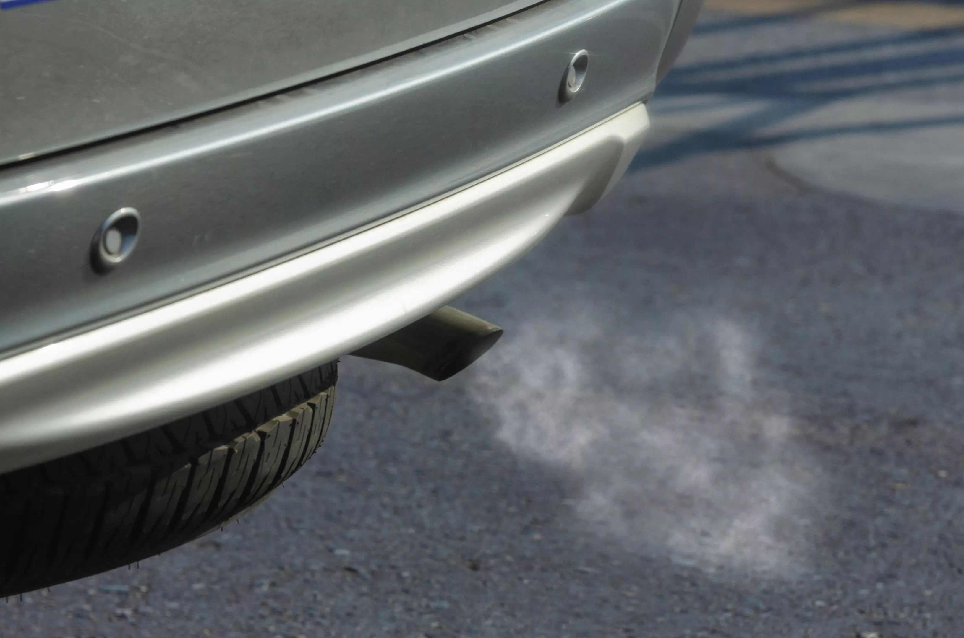 Car exhaust pipe with smoke coming out