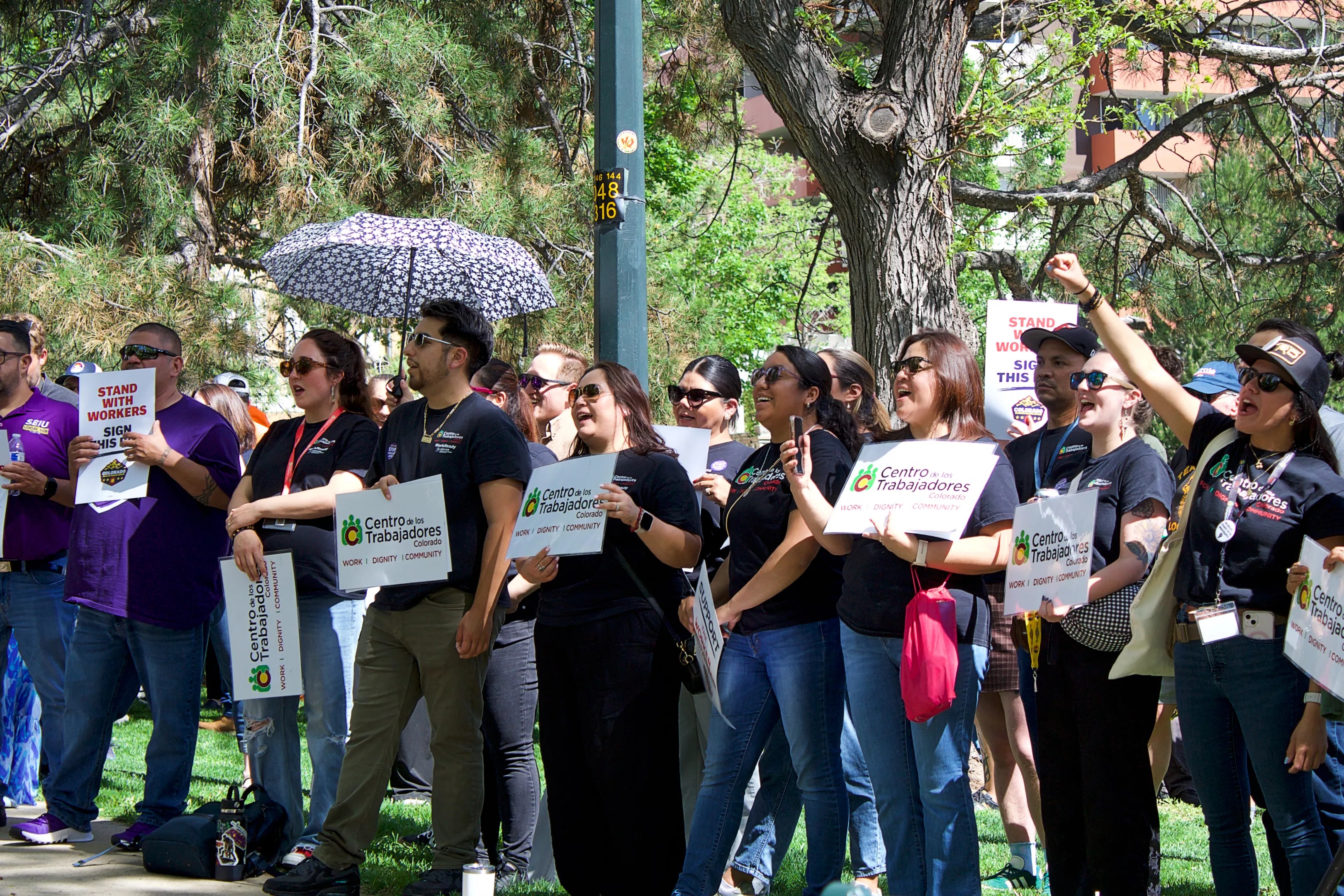 Labor advocates gather at Governor's Park in Denver to rally in support of a just-cause employment ballot measure proposal.