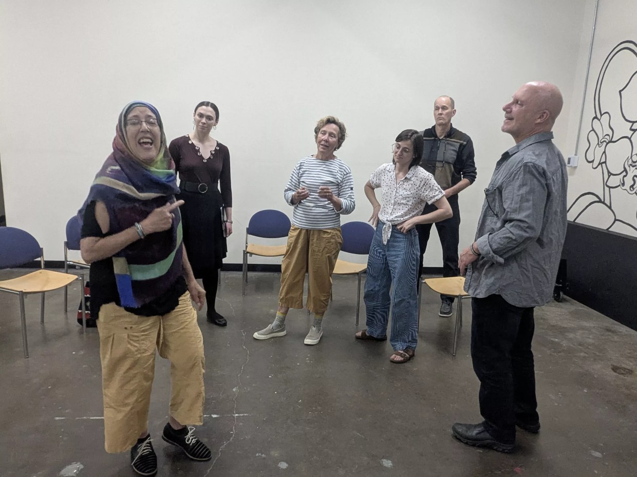 A group of people stands in a room.