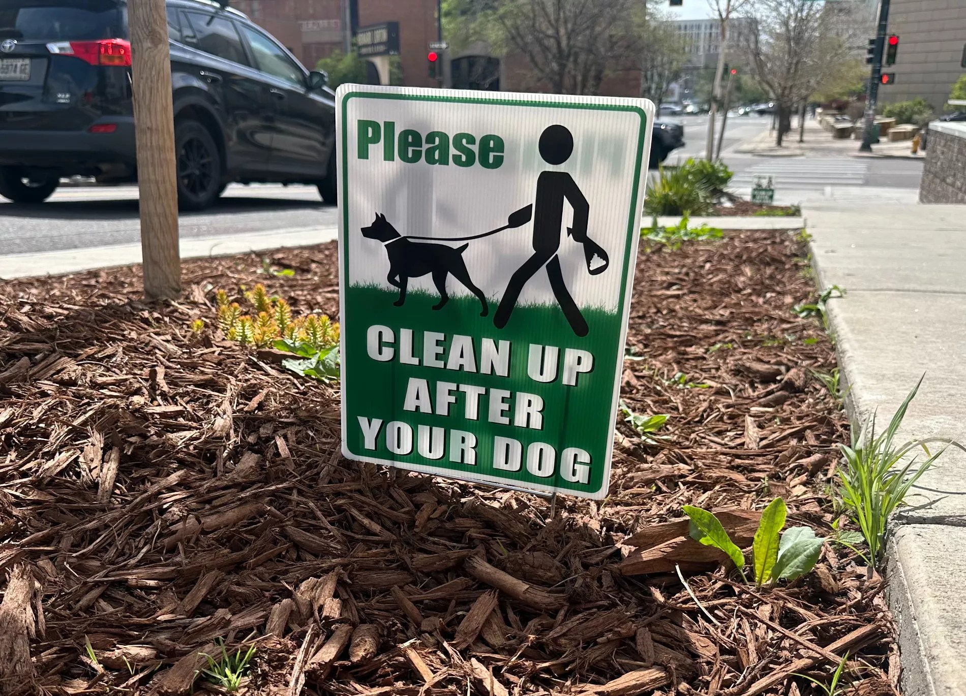 dog poop clean up sign on sidewalk