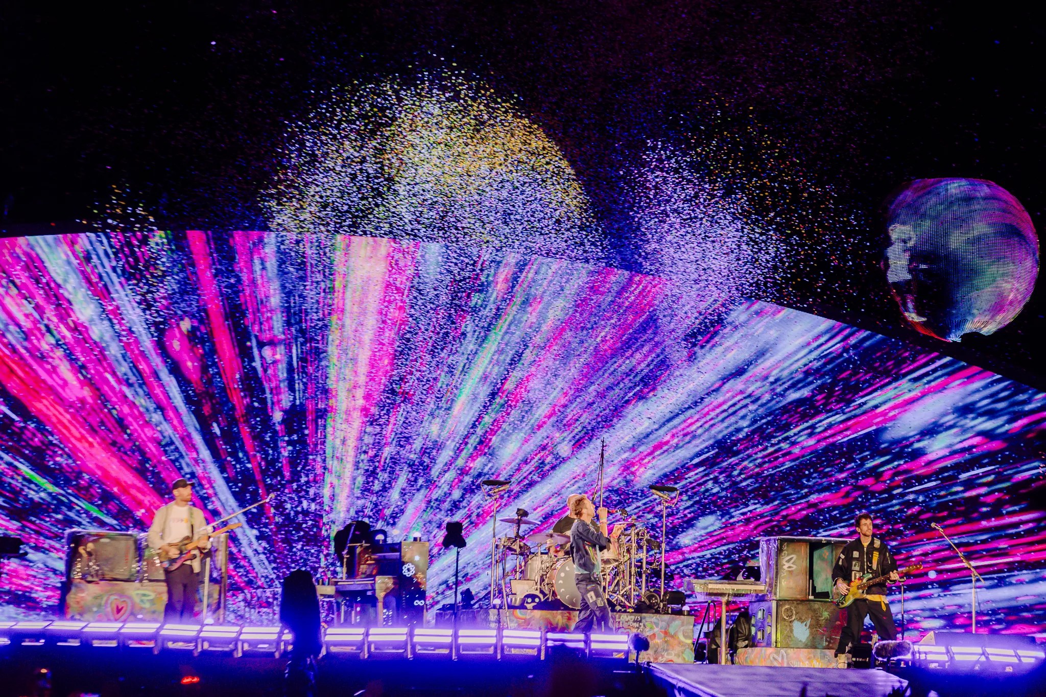 Coldplay on stage at Empower Field at Mile High.
