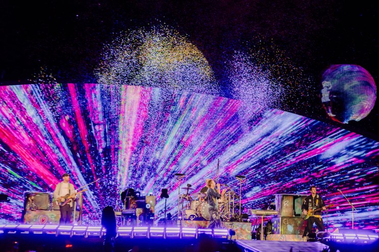 Coldplay on stage at Empower Field at Mile High.