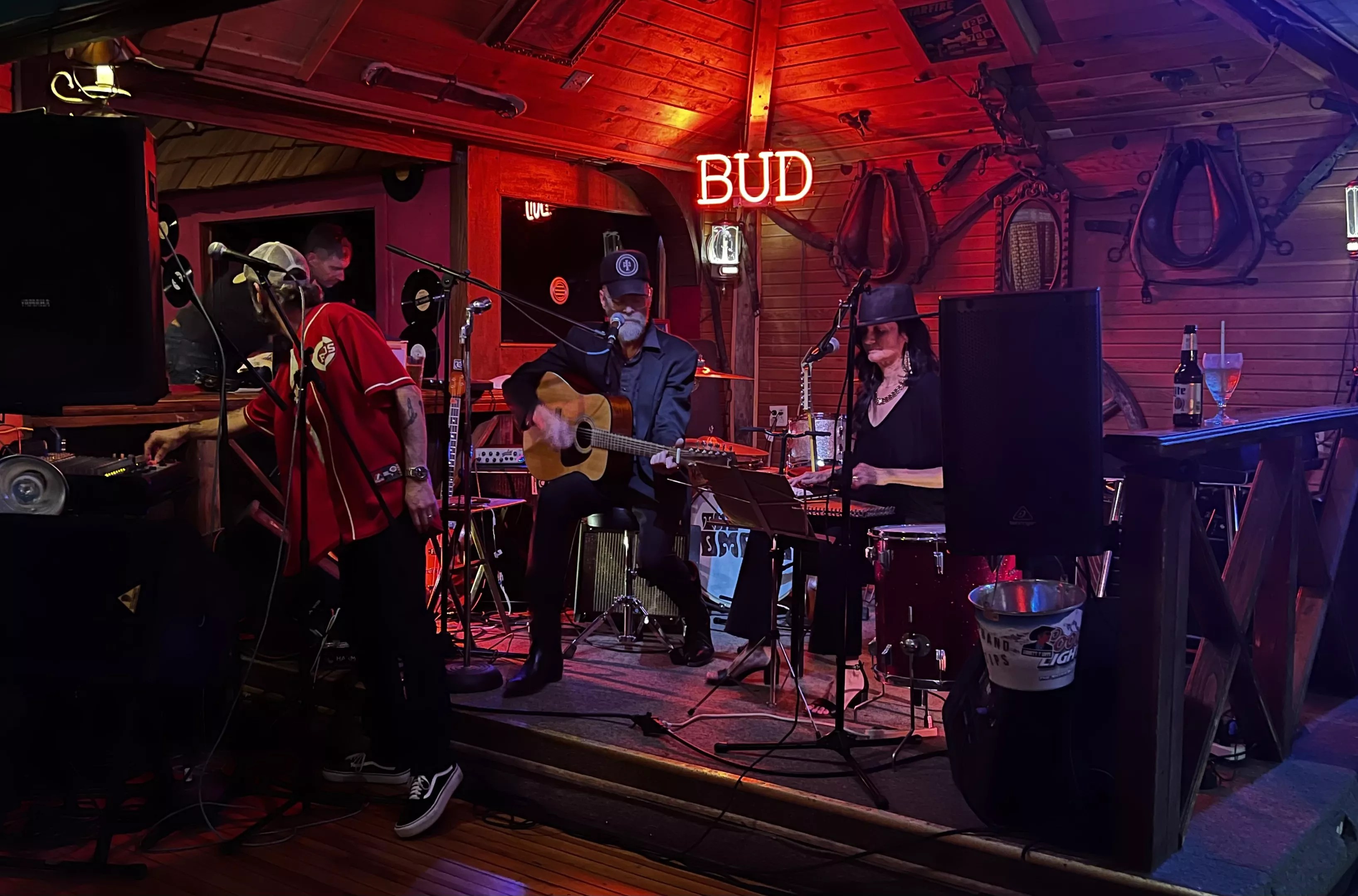 band performing on stage with red and purple lighting