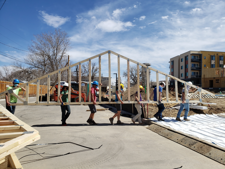 workers carrying part of houses
