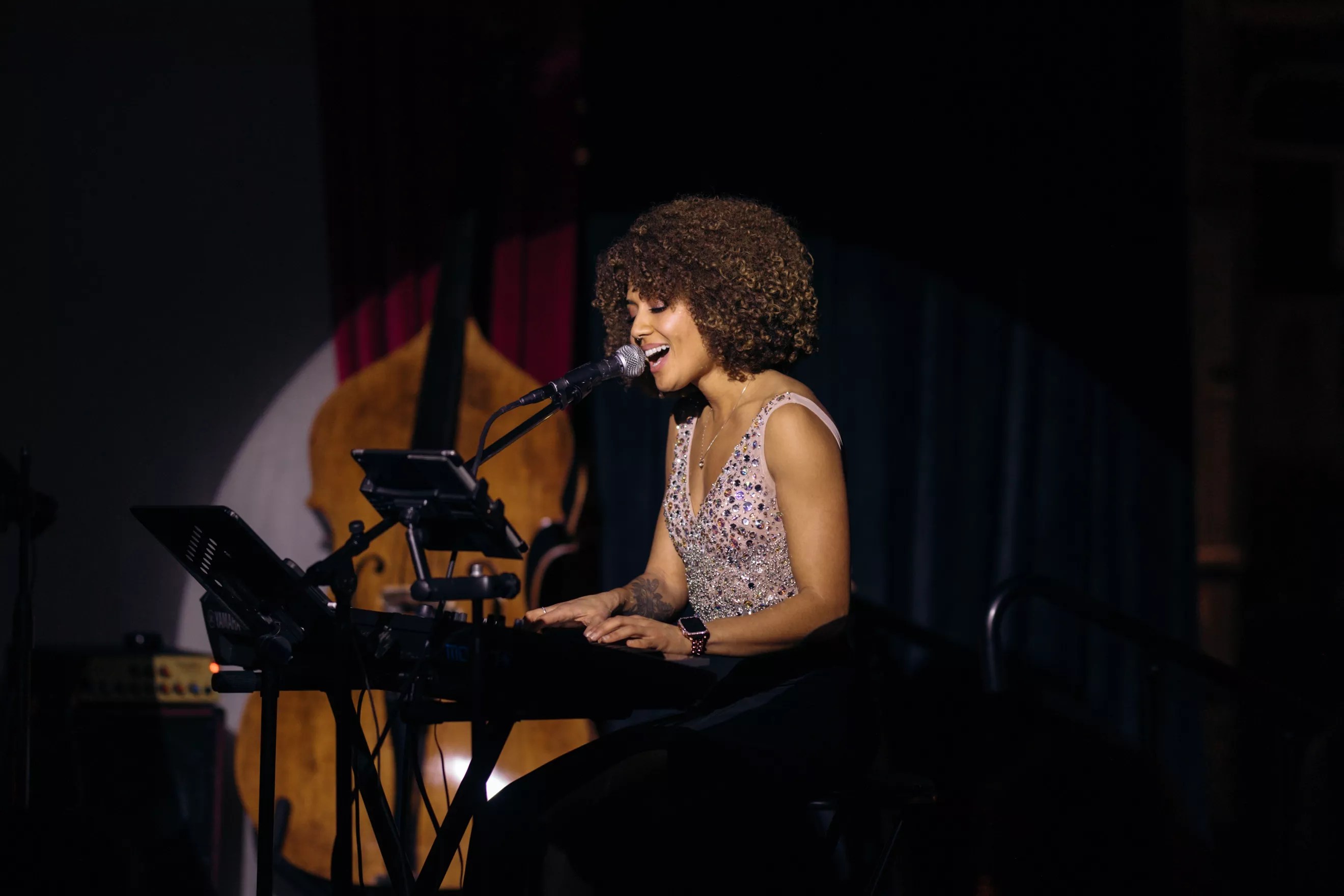 Singer Dzirae Gold performs at a piano