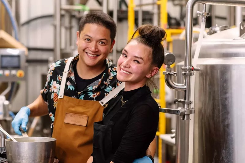 man and woman in kitchen.