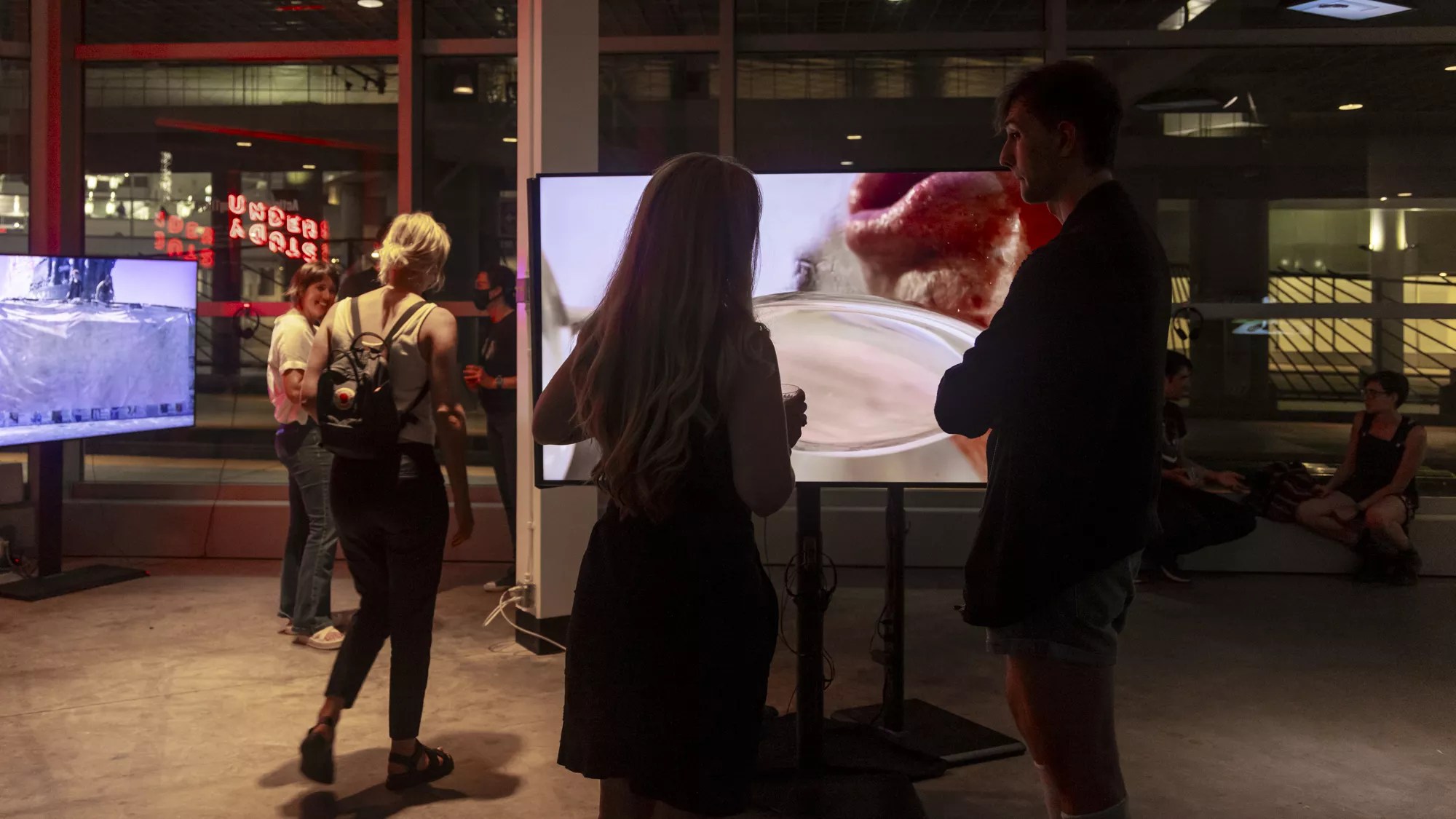 a woman watches a screen