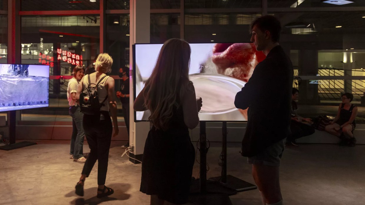 a woman watches a screen