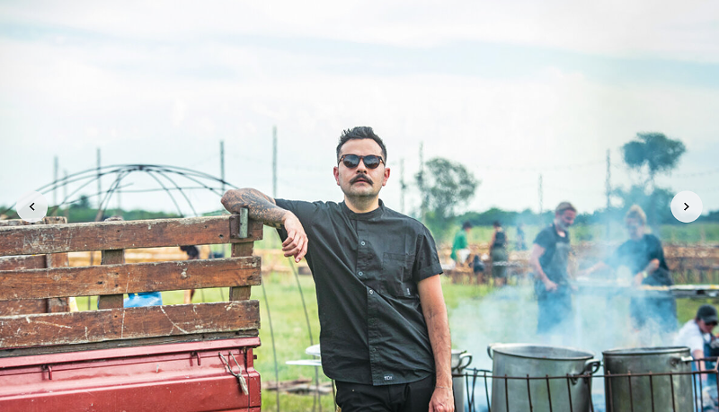 man in black shirt standing by truck