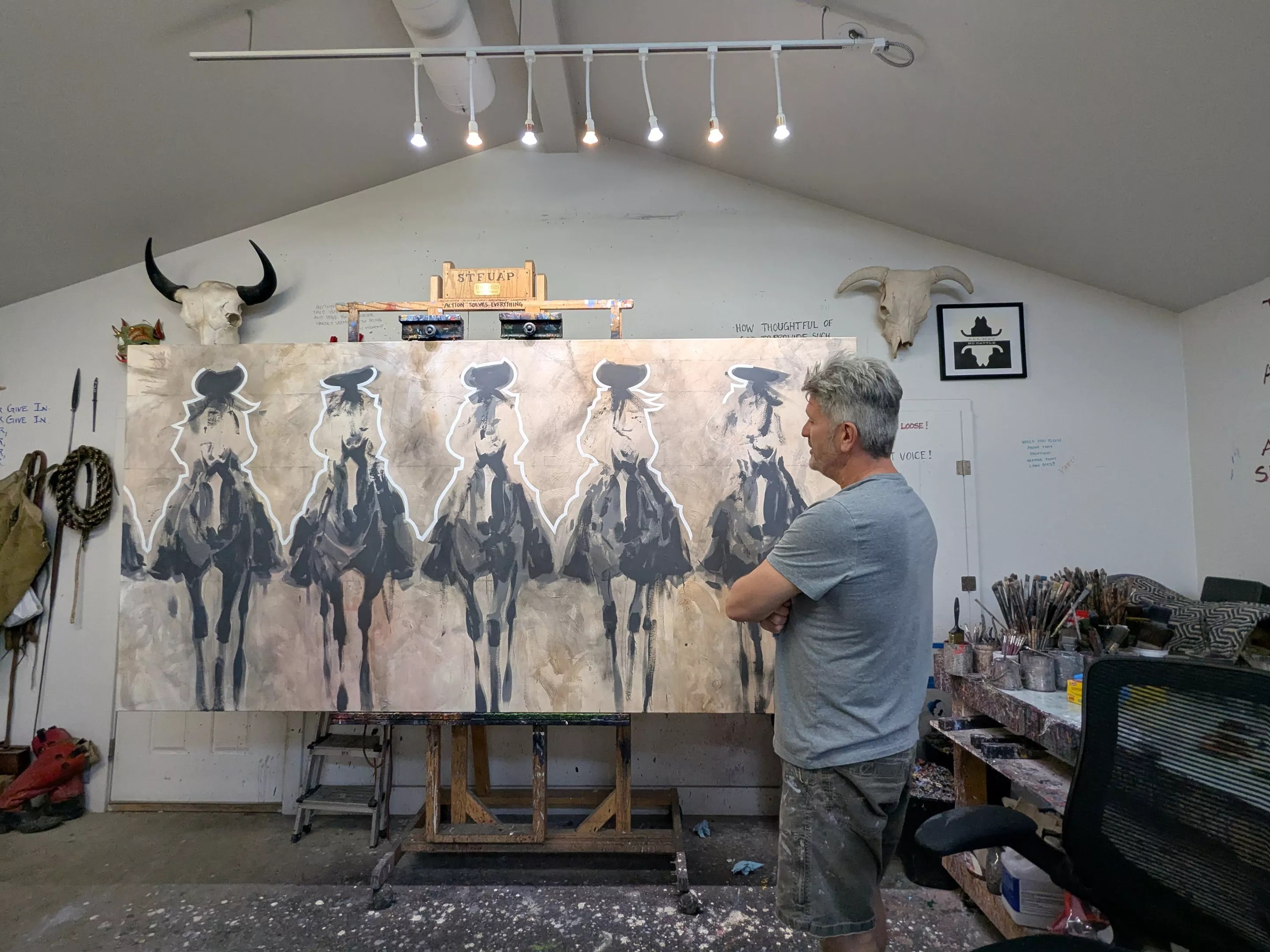 A man looks at his artwork