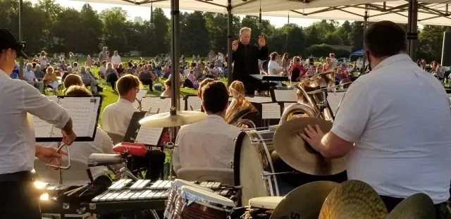 people watching the Denver Municipal Band outdoors