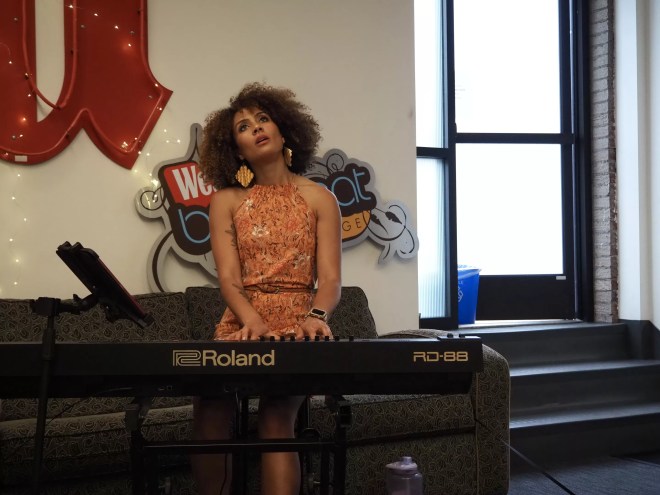 woman playing a piano and looking up