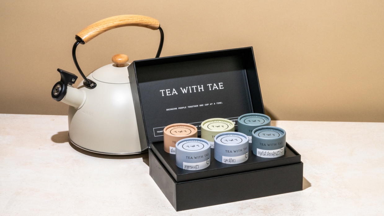A black gift box containing six tubes of tea sachets