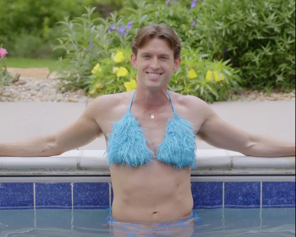 Connor Cole wears a fuzzy blue bikini set while in a pool, just like character Elle Woods did in Legally Blonde.