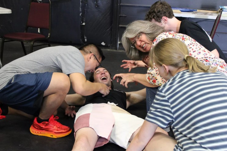 Actors rehearse a zombie play.