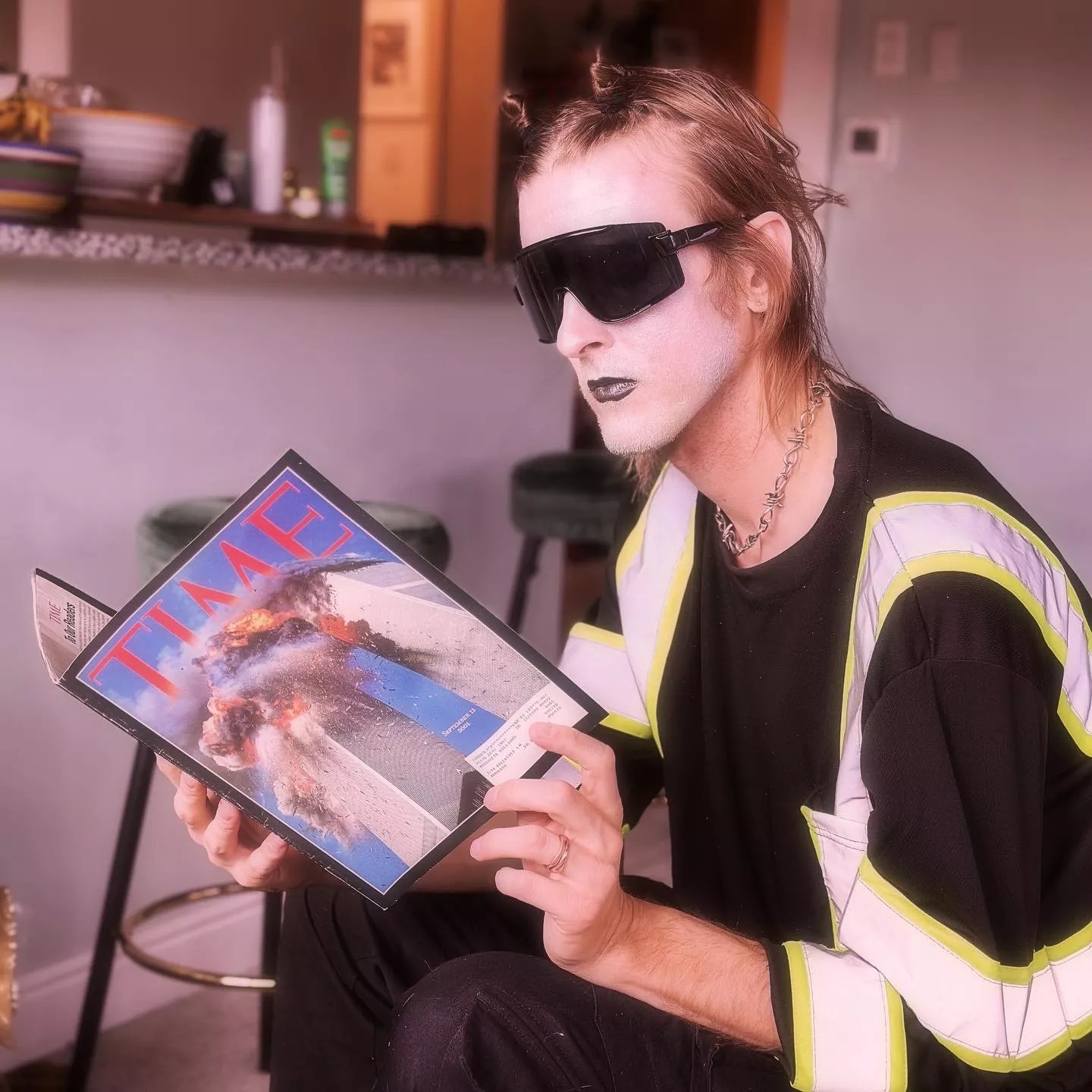 goth person looking at a magazine