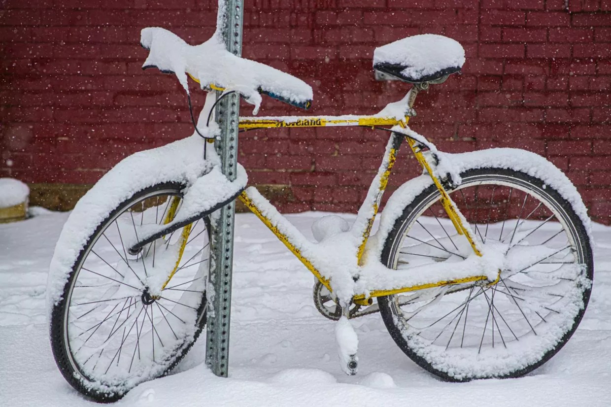 bike covered in snow on street