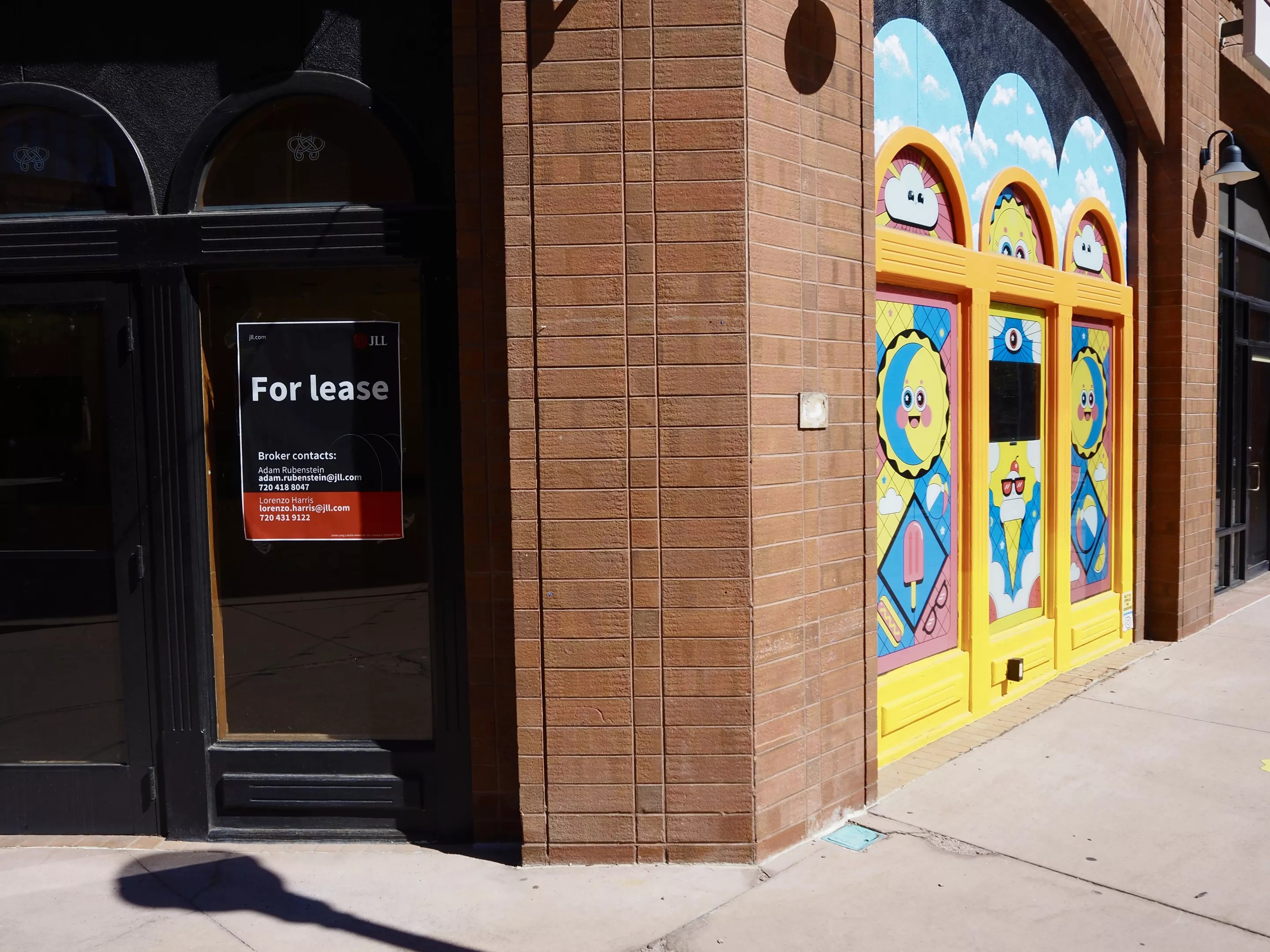 an empty storefront with colorful art