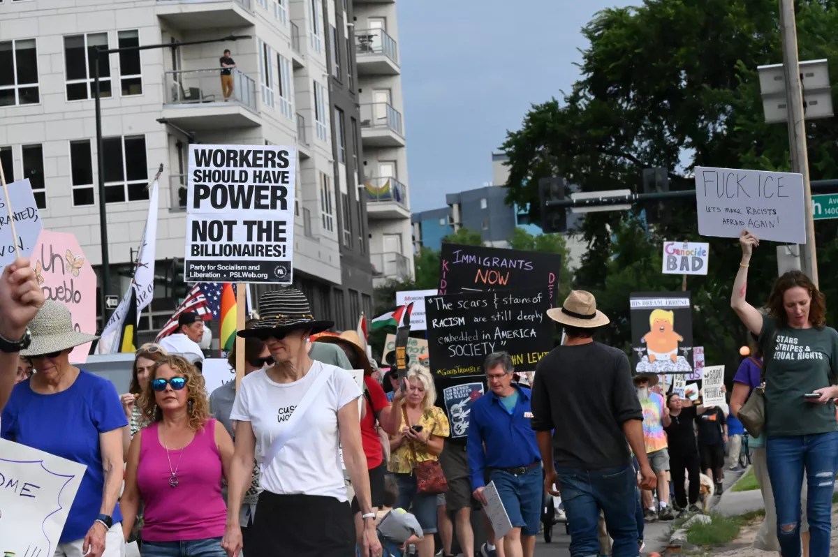 People walk with signs.