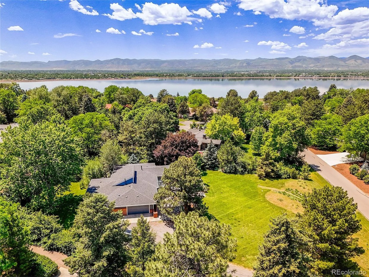 A four-bedroom home on a 0.9-acre lot in view of a large lake in Bel Mar, Colorado.