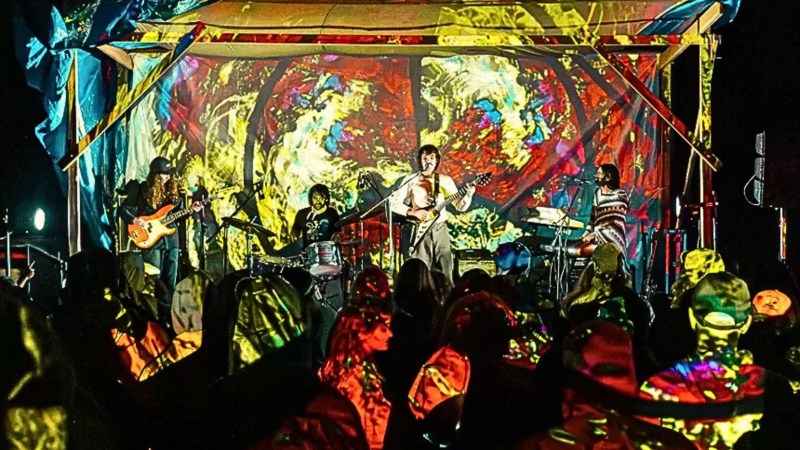 musicians performing under psychedelic lighting