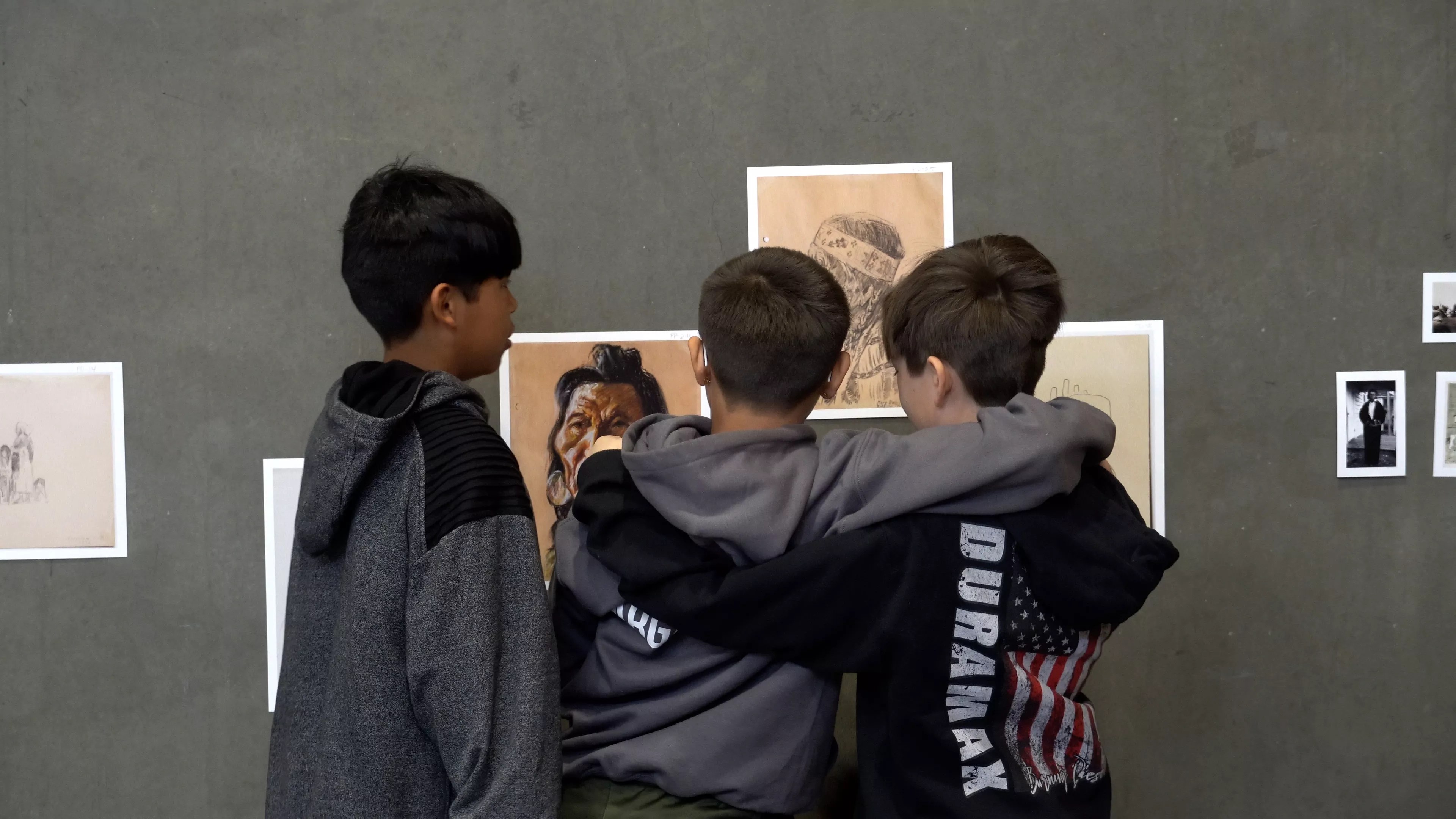 Kids gather around art.