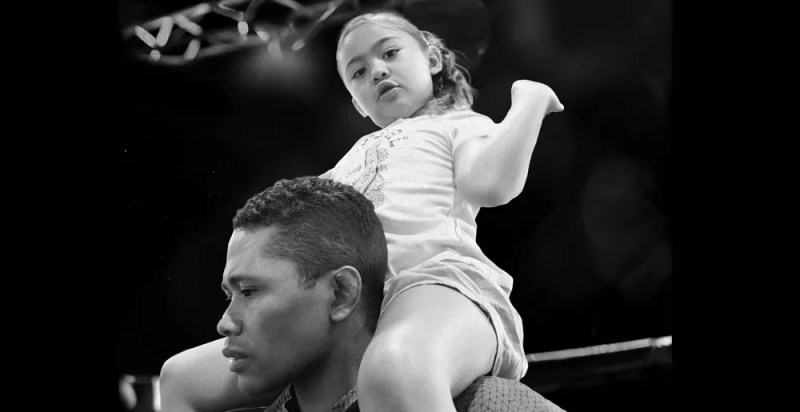 man with little girl on shoulders.