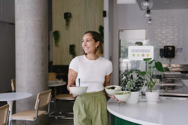 woman holding two bowls